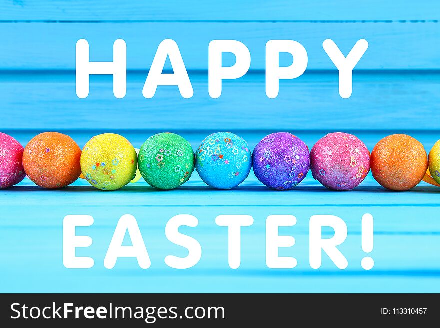 Colorful Easter Egg On Blue Pastel Color Wood Background With Space. Happy Easter.