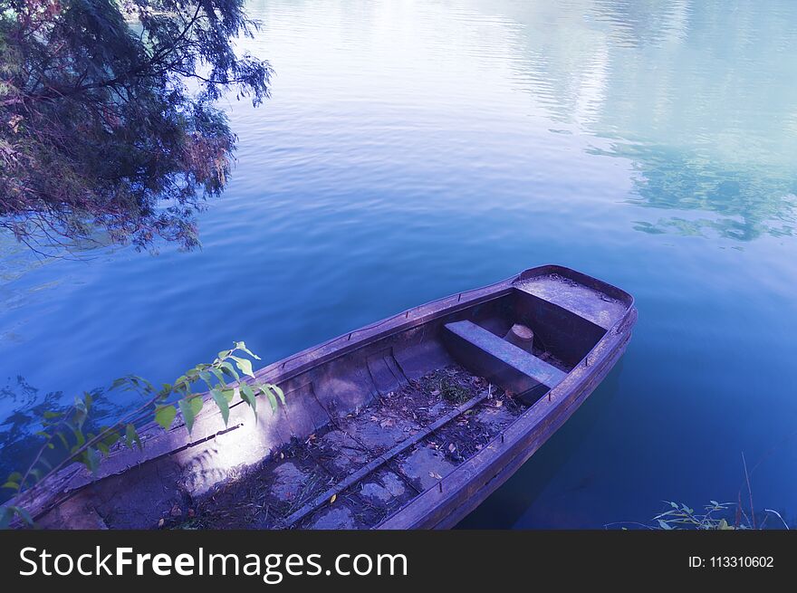 Row boat in calm blue water