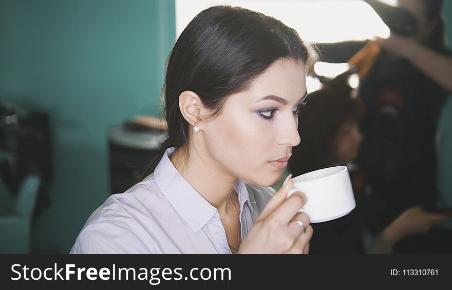 Woman at the hair salon drink coffee, close up