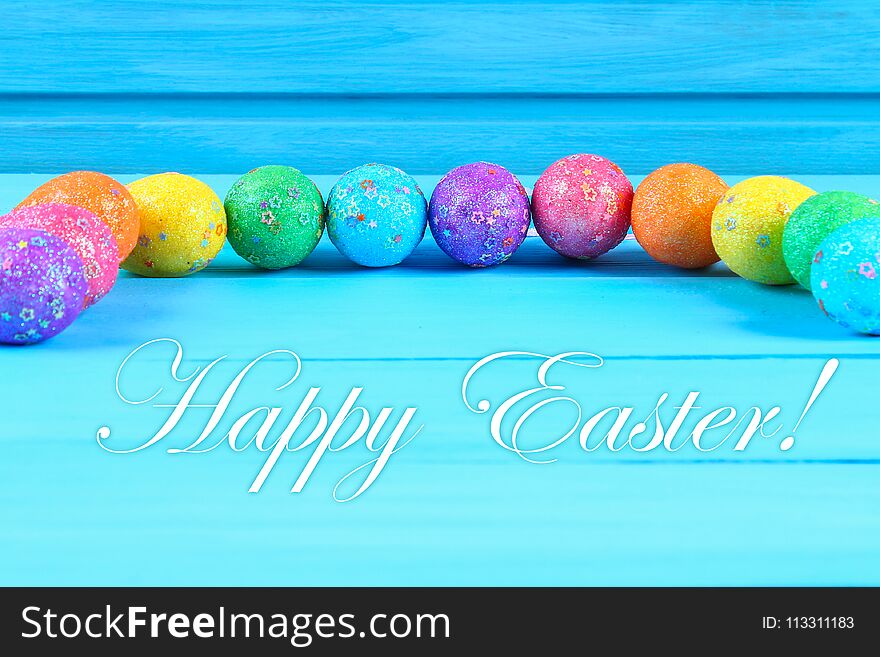 Colorful easter egg on blue pastel color wood background with space. Happy easter.