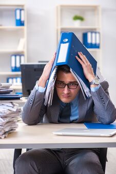The Overloaded With Work Employee Under Paperwork Burden Stock Photography