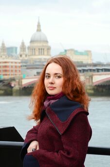 London Girl. Portrait Of Beautiful Smiling Happy Young Woman Near The Thames River On The Background St Paul`s Cathedral In London Royalty Free Stock Image
