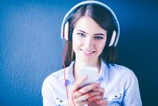 Young Happy Girl Sitting On Floor And Listening Music Royalty Free Stock Photo