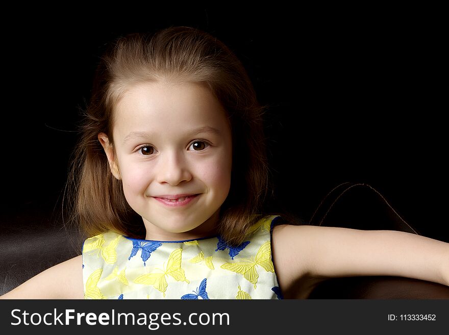 Beautiful little girl, studio portrait on a black background. The concept of a happy childhood, style and fashion. Beautiful little girl, studio portrait on a black background. The concept of a happy childhood, style and fashion.