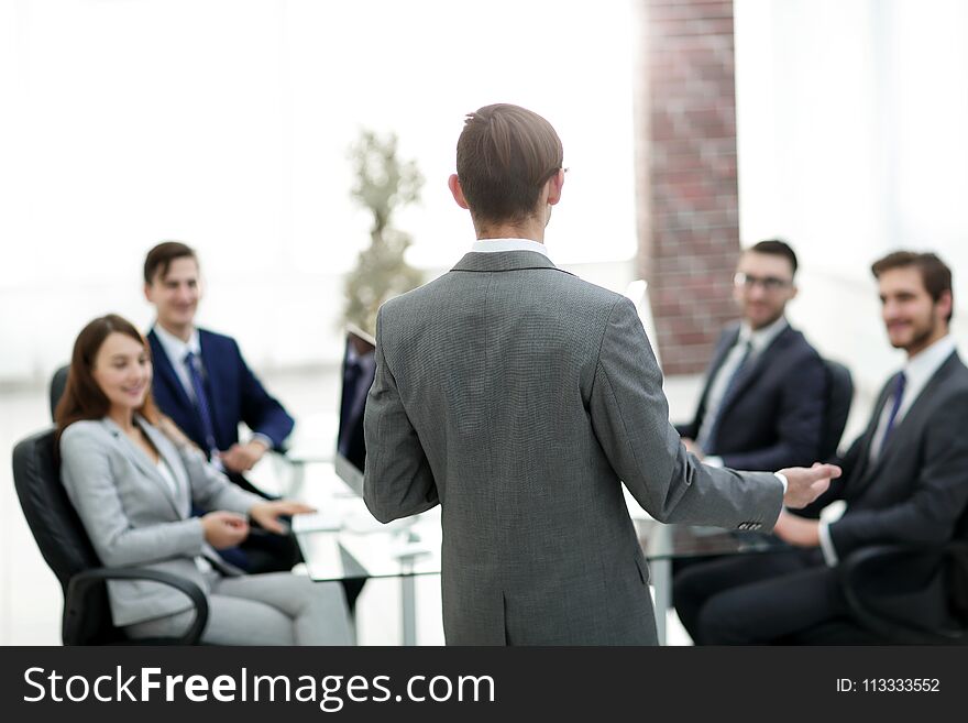 Rear view portrait of men giving business presentation to colleagues in conference room. Rear view portrait of men giving business presentation to colleagues in conference room.
