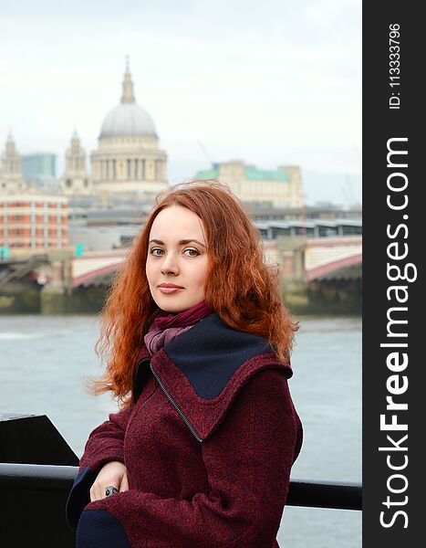 London Girl. Portrait Of Beautiful Smiling Happy Young Woman Near The Thames River On The Background St Paul`s Cathedral In London