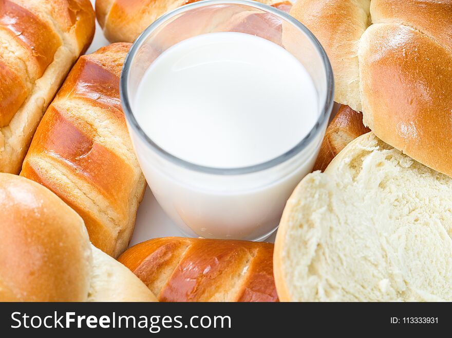 Close-up, top view, Breakfast milk and bread rolls, white background. Close-up, top view, Breakfast milk and bread rolls, white background