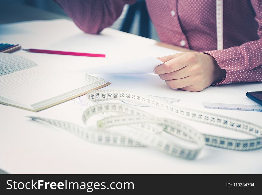 Young fashion designer working at studio.