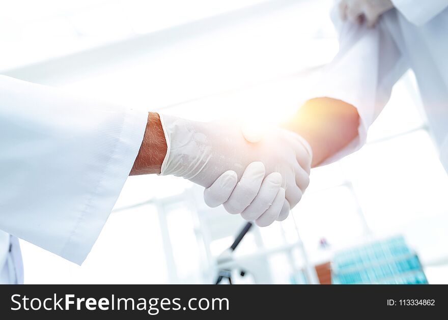 Close-up Of Two Doctor`s With Glove Shaking Hand. Close-up Of Two Doctor`s With Glove Shaking Hand