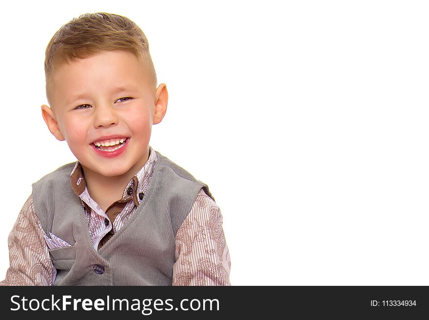 A beautiful little boy laughs fun. The concept of a happy childhood, well-being and family values. Isolated on white background. A beautiful little boy laughs fun. The concept of a happy childhood, well-being and family values. Isolated on white background.