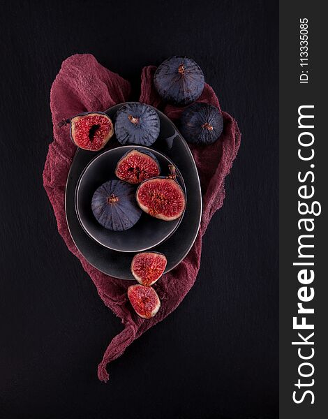 Fresh ripe figs, rustic food photography on slate plate kitchen table can be used as background