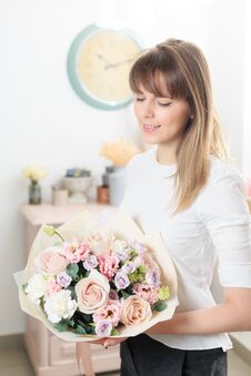 Beautiful Luxury Bouquet Of Mixed Flowers In Woman Hand. The Work Of The Florist At A Flower Shop. A Small Family Royalty Free Stock Images