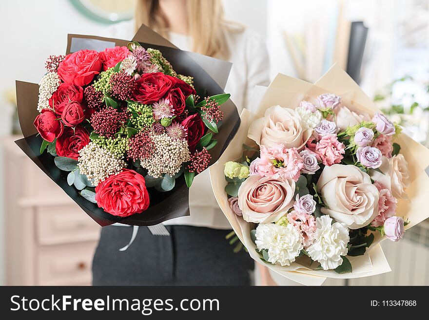 Beautiful luxury bouquet of mixed flowers in woman hand. the work of the florist at a flower shop. A small family business.