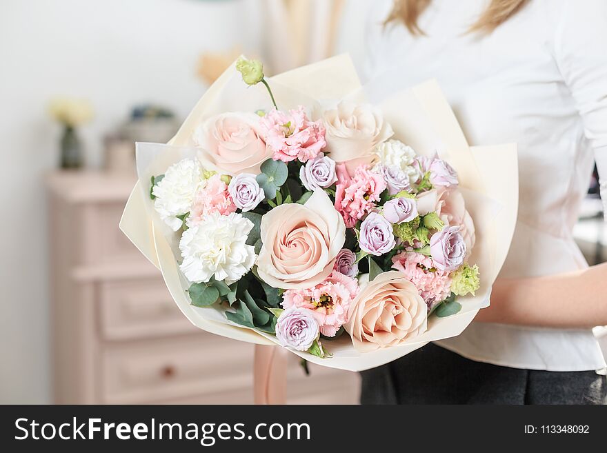 Beautiful Luxury Bouquet Of Mixed Flowers In Woman Hand. The Work Of The Florist At A Flower Shop. A Small Family