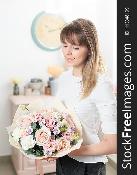 Beautiful luxury bouquet of mixed flowers in woman hand. the work of the florist at a flower shop. A small family