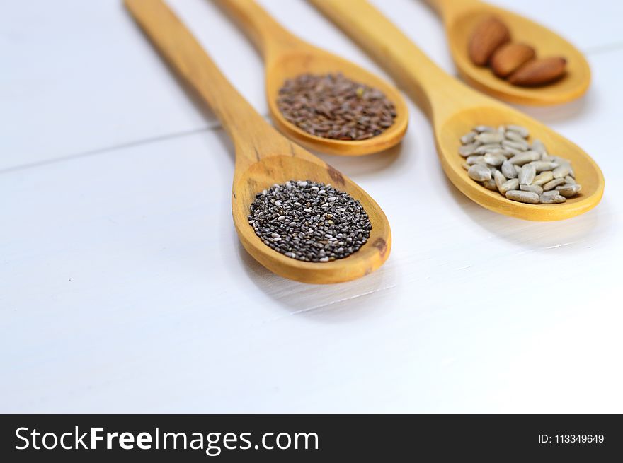 Closeup Photo of Four Brown Wooden Spatulas With Seds