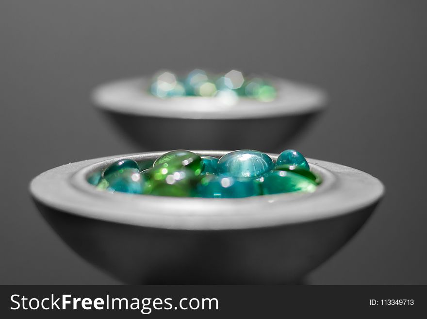 Multicolored Pebbles on White Ceramic Bowl