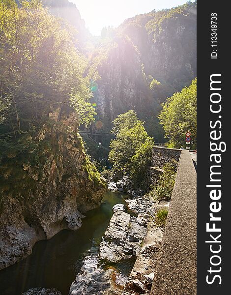 A deep gorge with a river in the mountains of Italy.