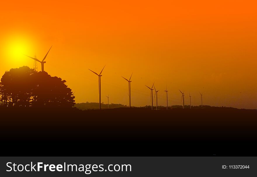 Wind turbines silhouette with sunset at the khao kho park, Thailand. Wind turbines silhouette with sunset at the khao kho park, Thailand.
