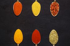 Spices In Silver Spoons, Turmeric, Paprika, Cardamom, Basil. On A Wooden Table. View From Above. Royalty Free Stock Images