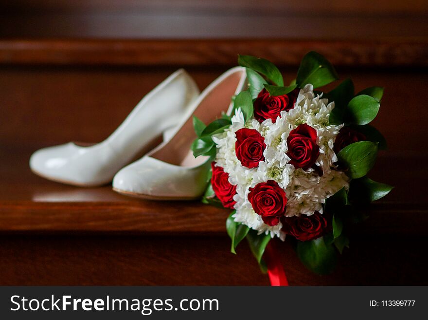 Tender beautiful bridal bouquet of flowers on wooden steps