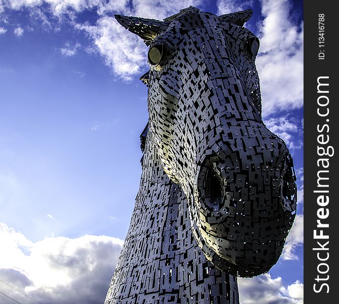 Macro Photography Of Mechanical Horse Face Under White And Blue Cloudy Sky