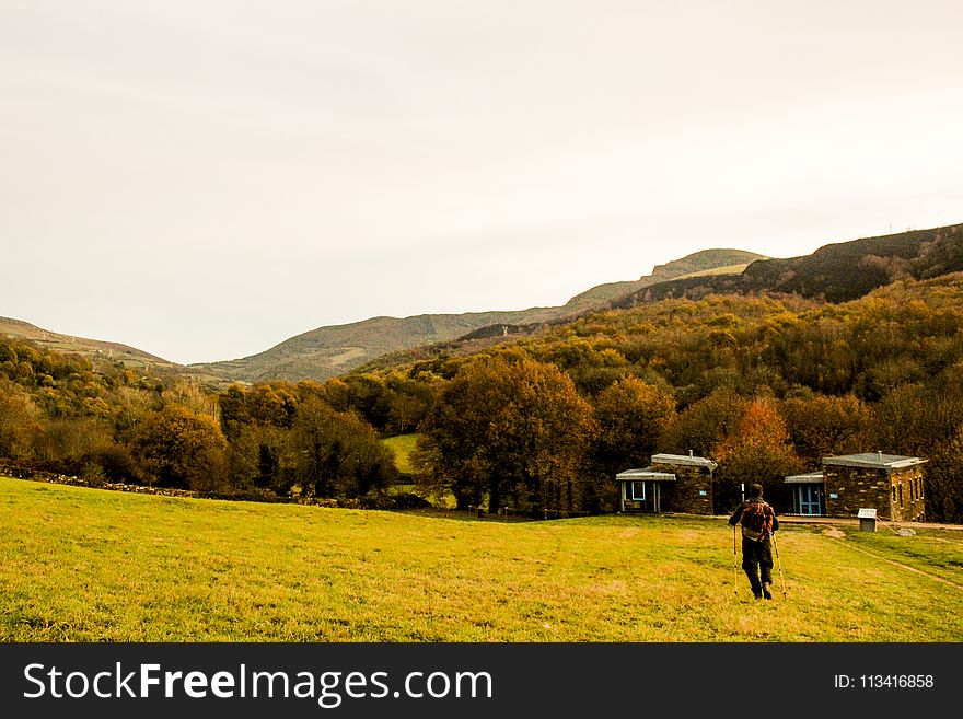 Person Standing At Green Field