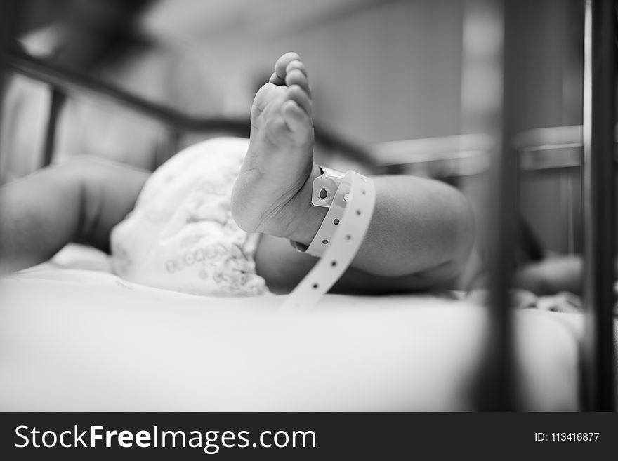 Grayscale Photography of Baby Laying