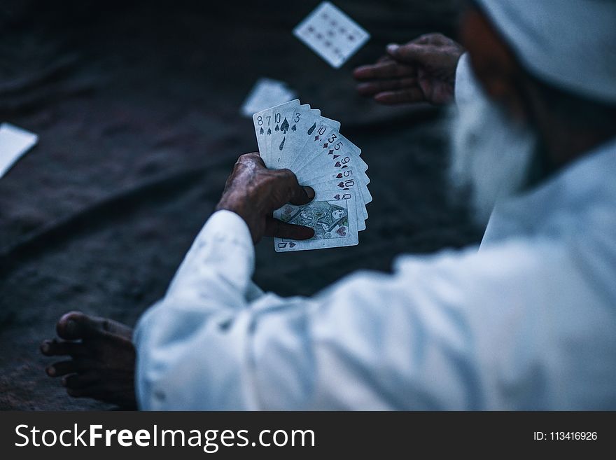 Person Holding Playing Cards