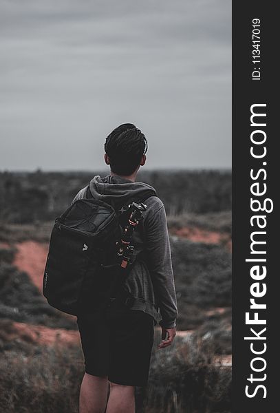 Photo of a Man Wearing Black Backpack