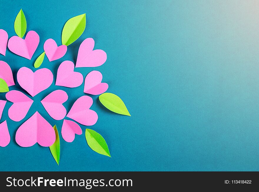 Pink paper cut heart shape and leaf on blue background. Pink paper cut heart shape and leaf on blue background.