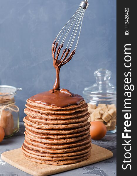 Pancake cake. A stack of chocolate pancakes with chocolate cream. Pancake cake. A stack of chocolate pancakes with chocolate cream.