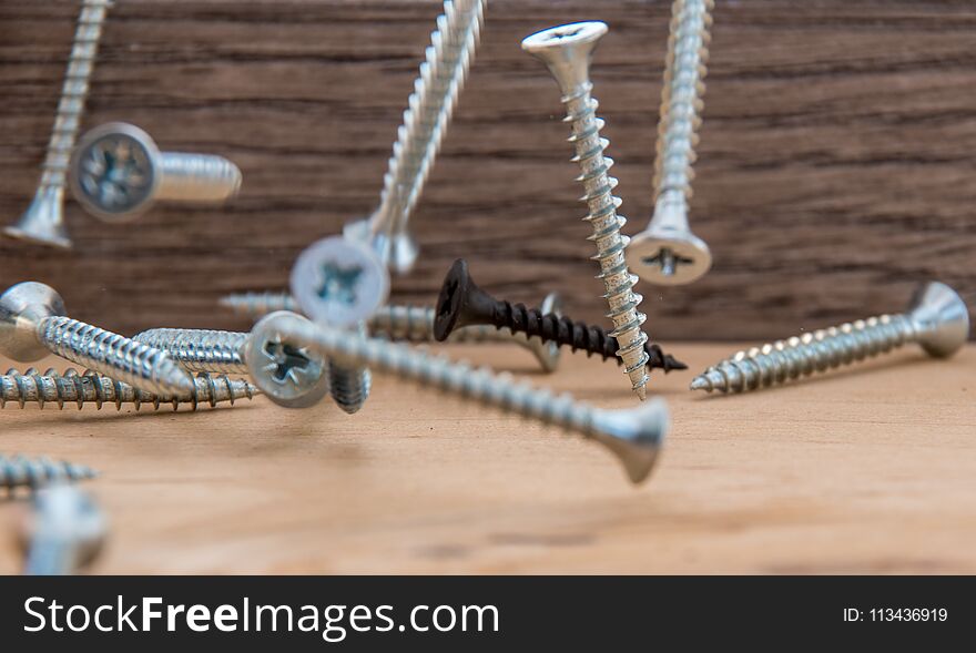 The falling bolts and screws on the tree are suspended in the air. It looks like weightlessness.