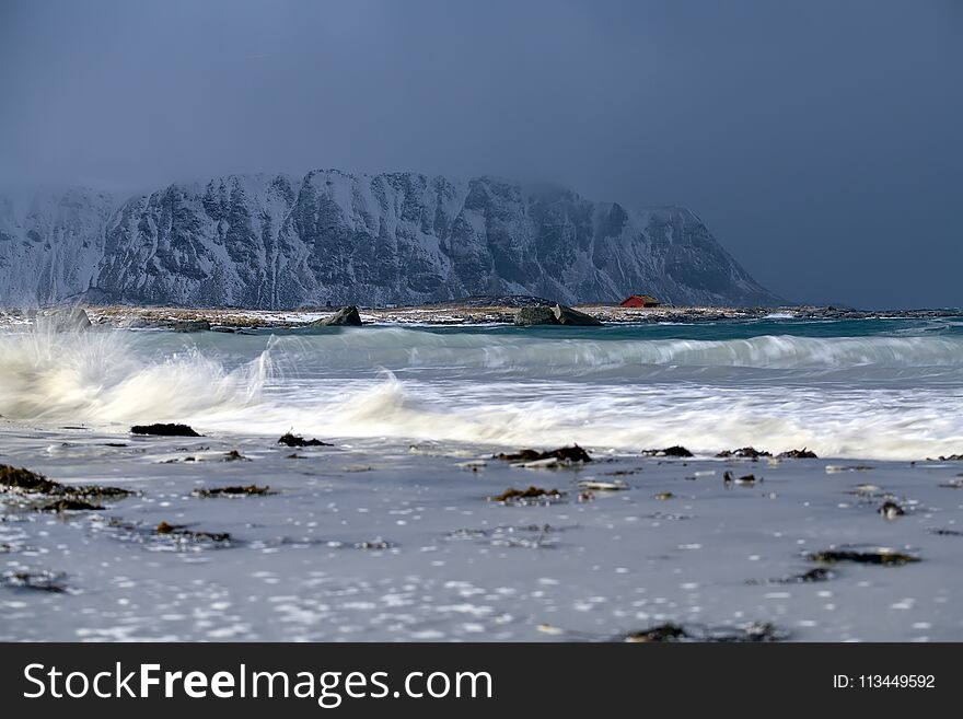 Storm waves on the beach in Lofoten Archipelago, Norway in the winter time