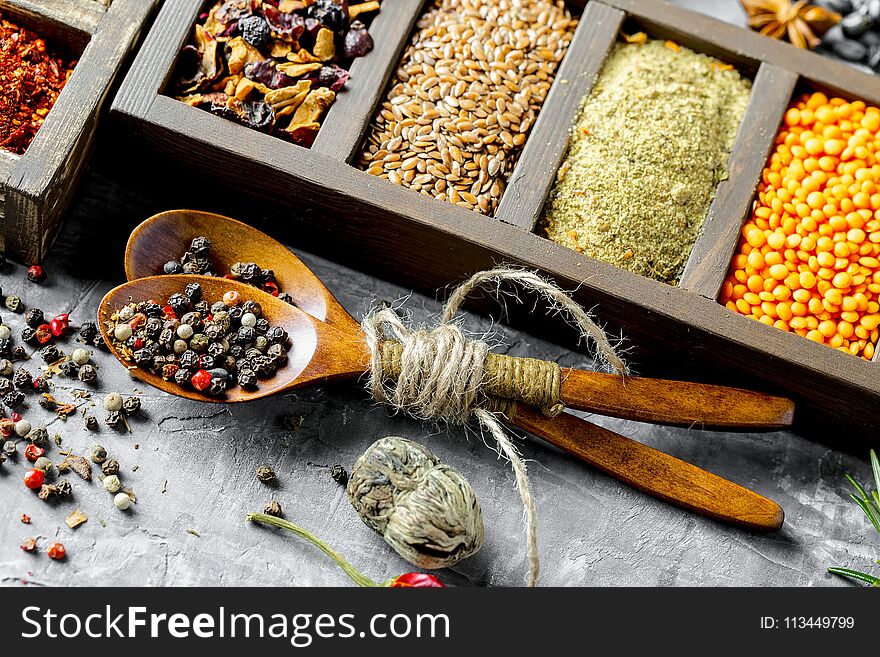 Spices for cooking with kitchen accessories on an old background