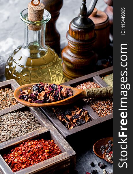 Spices for cooking with kitchen accessories on an old background