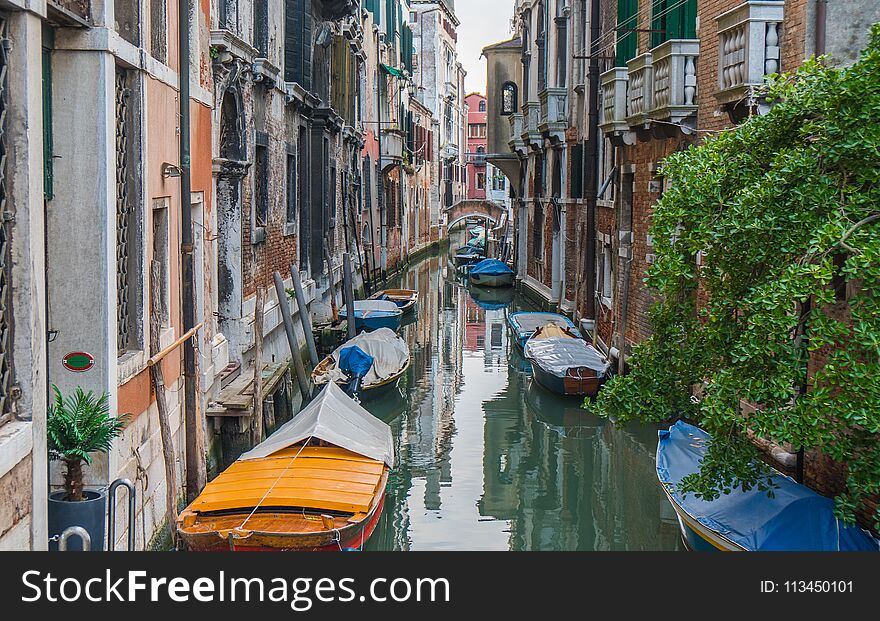 Small pretty canal with boats in Venice. Small pretty canal with boats in Venice