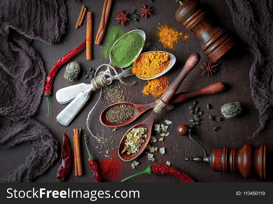 Spices for cooking with kitchen accessories on an old background