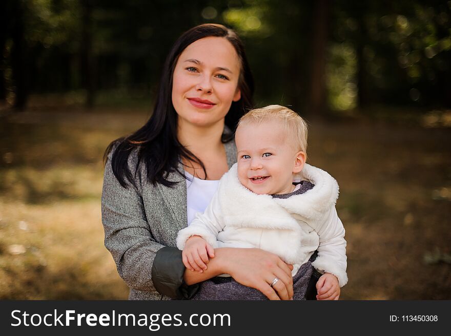 Smiling brunette mother with a cute little daughter