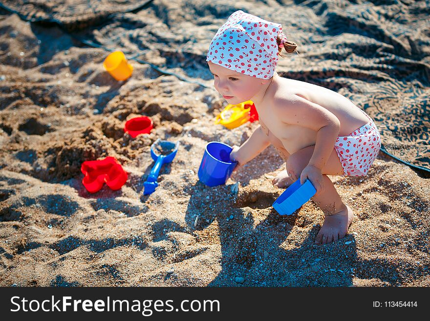 Little Girl Playing In Sand