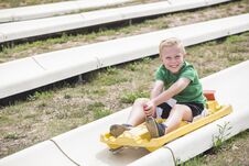 Smiling Boy Riding A Downhill Coaster Ride Outdoors In The Summer Stock Images Smiling Boy Riding A Downhill Coaster Ride Outdoors In The Summer Stock Images