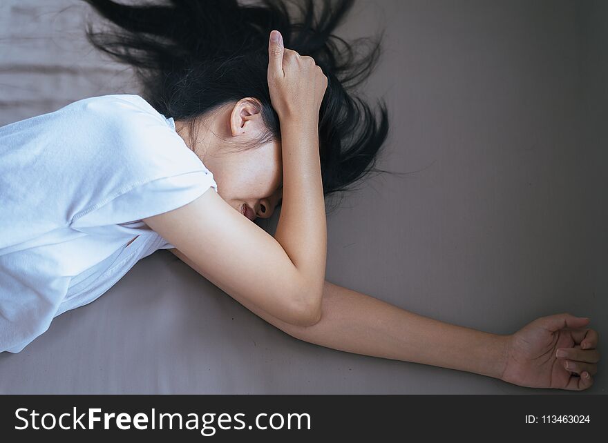 Asian woman have a headache on bedroom after wake up in the morning