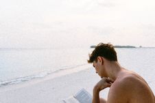 Free Topless Man Reading Book While Seating At Beach Stock Images - 113472864