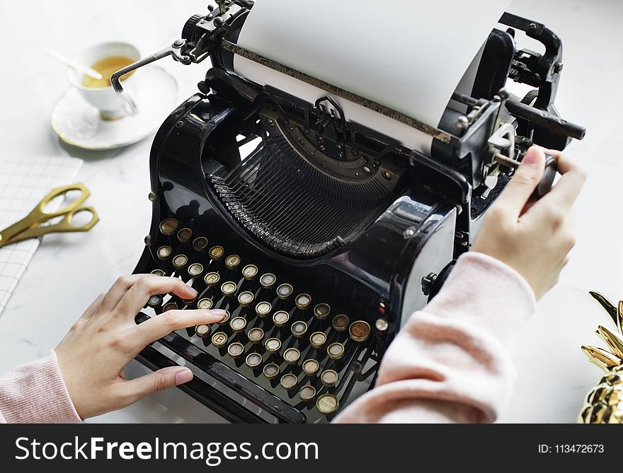Woman Uses Black Typewriter