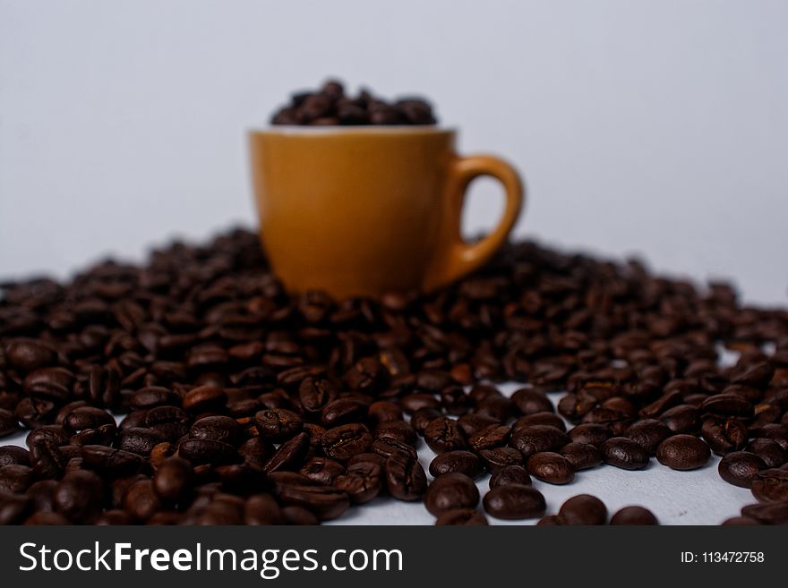 Brown Mug Filled With Coffee Beans
