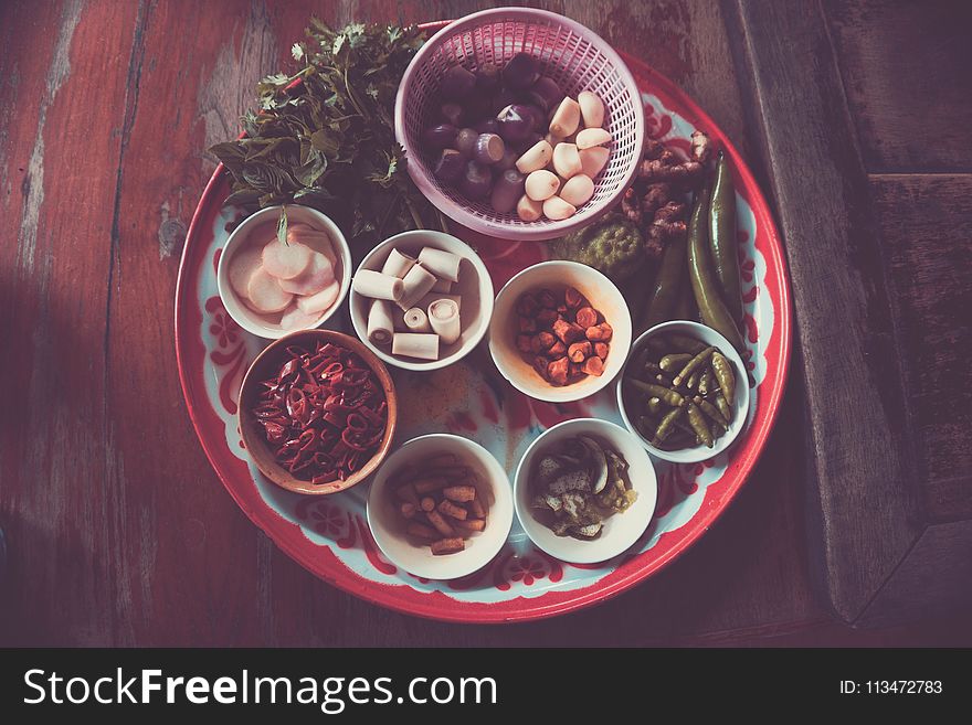 Assorted Spices on White and Red Plate on Brown Wooden Table
