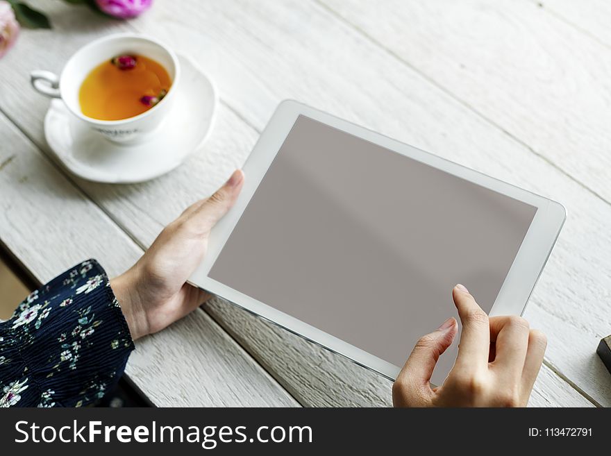 White Ipad On Hand