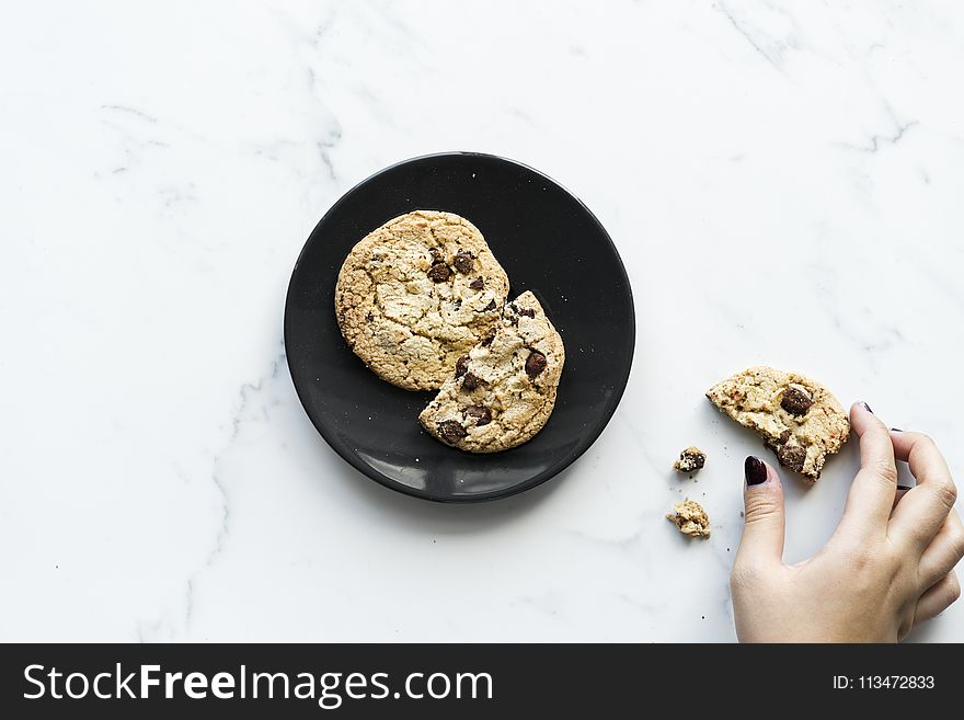 Two Cookies On Black Ceramic Plate