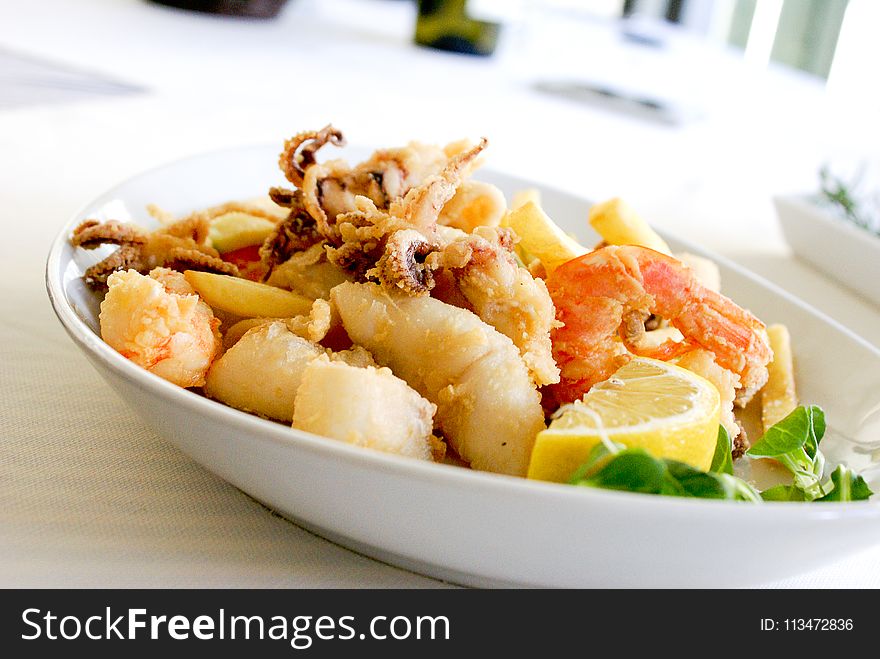 Deep Fried Shrimp and Squid With Slice of Lemon on Ceramic Plate