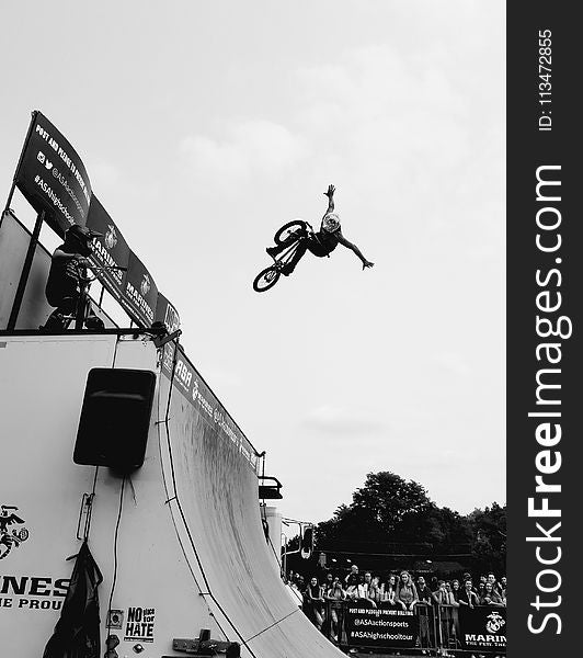 Grayscale Photo of Bmx Rider on Tournament